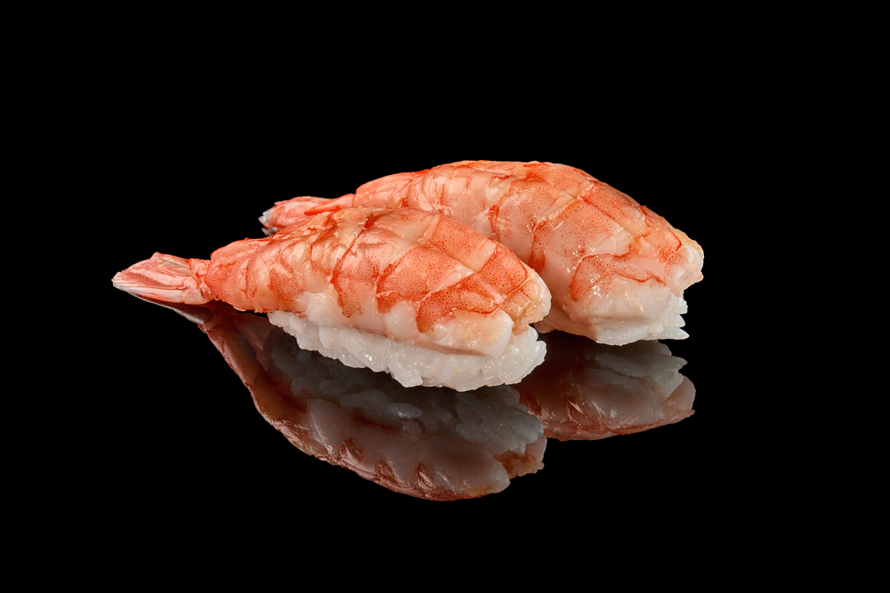 Two,Shrimp,Nigiri,Sushi,On,Black,Background,With,Reflection